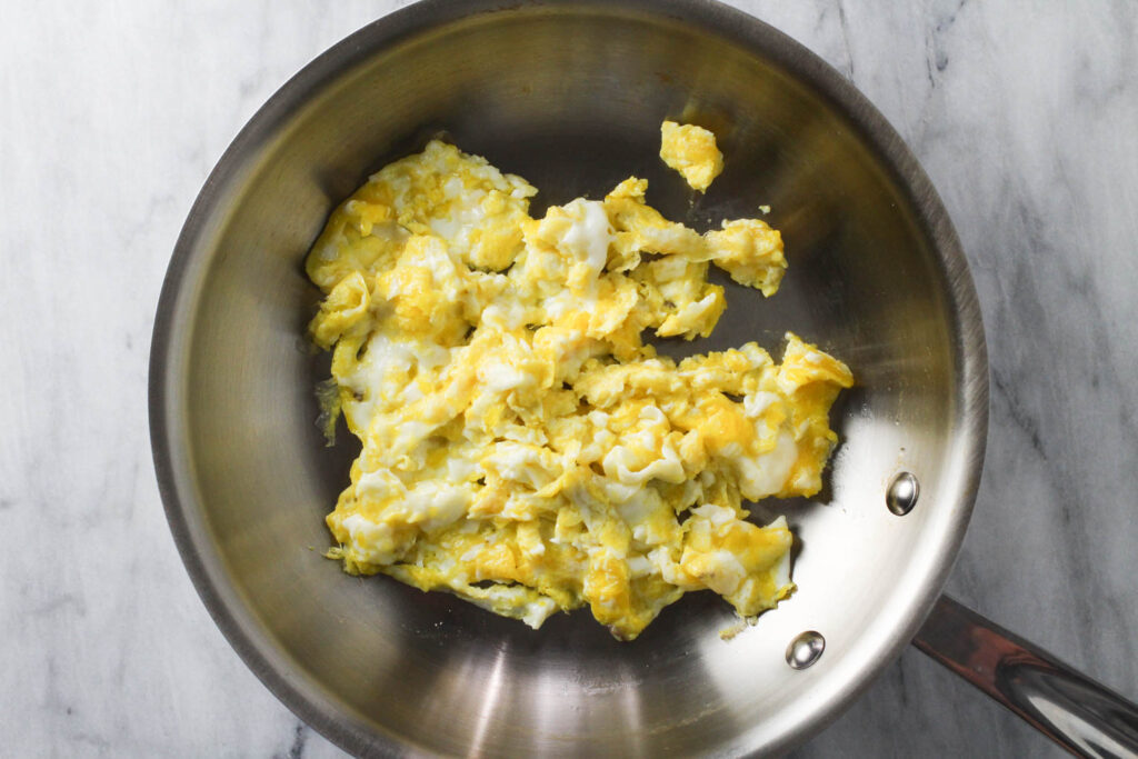 Scrambled eggs in a skillet.