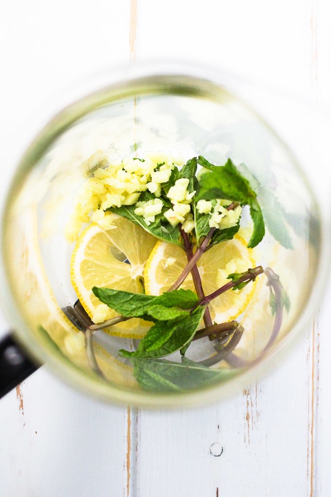 Minced ginger, mint leaves and lemon sliced in a French press.