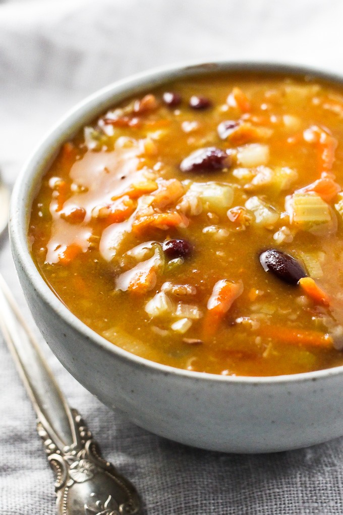 Bulgur soup in a bowl. A silver spoon to the left of the bowl.