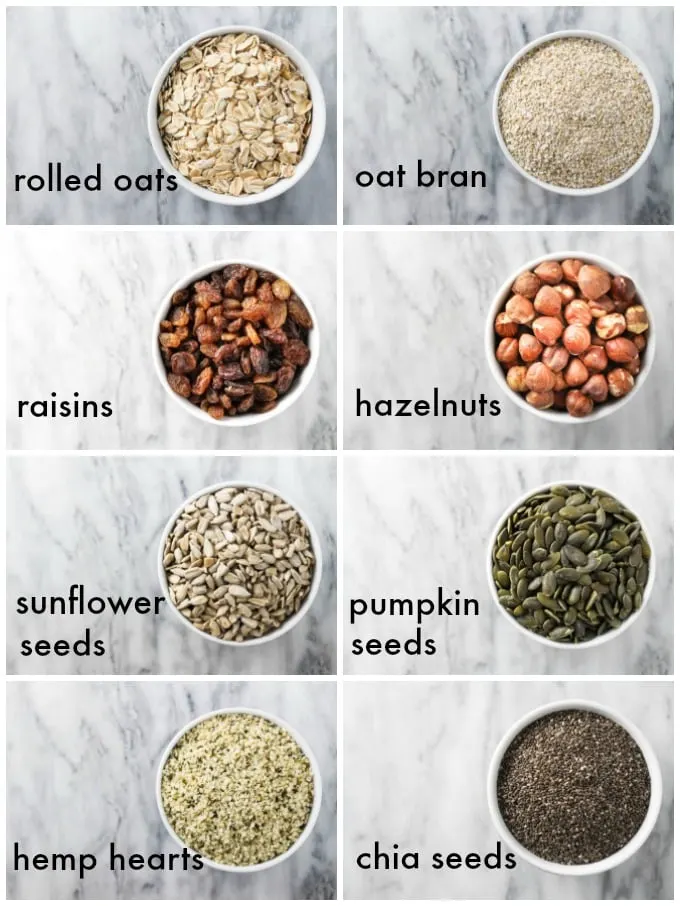 Collage of the muesli ingredients labeled as follows: rolled oats, oat bran, raisins, hazelnuts, sunflower seeds, pumpkin seeds, hemp hearts, chia seeds.