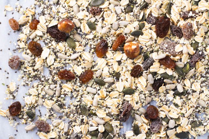 Homemade muesli sprinkled over light back ground.