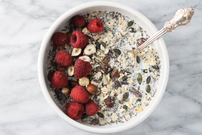 Homemade muesli in a bowl. Garnished with red raspberries.