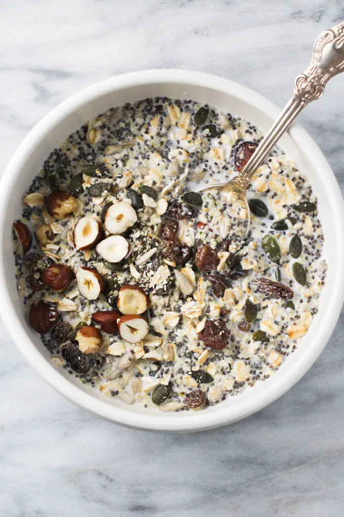 The homemade muesli in a bowl with silver spoon in it.