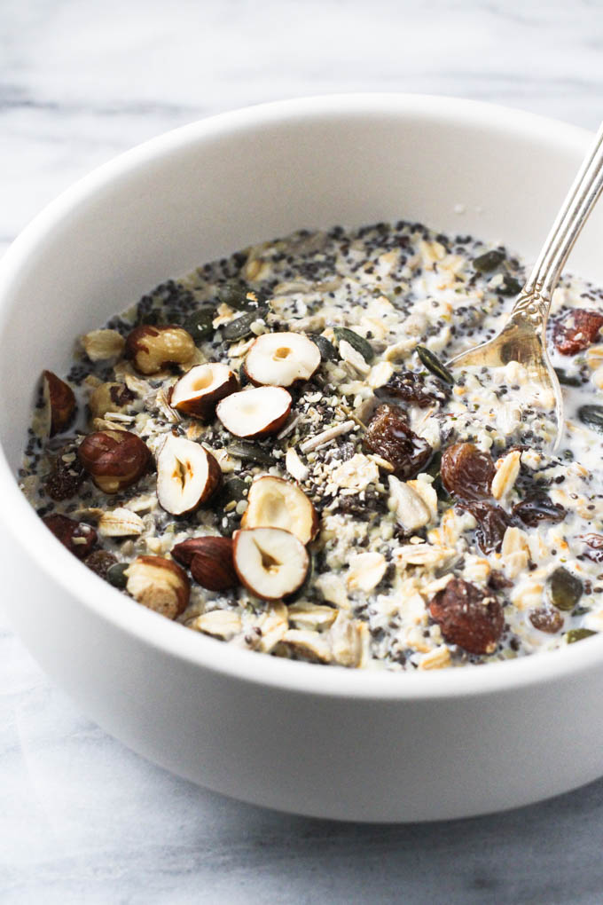 The homemade muesli in a bowl with a silver spoon.