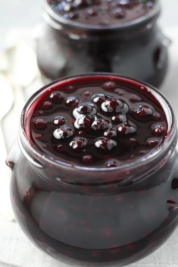 Healthy blueberry sauce in glass jars.