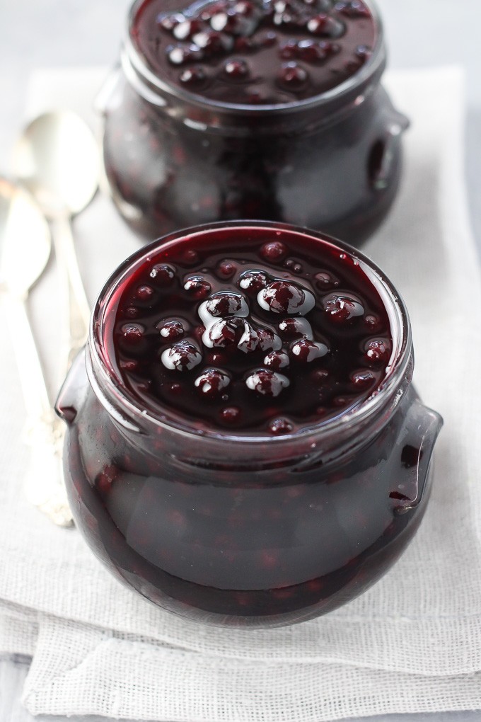 Healthy blueberry sauce in glass jars.