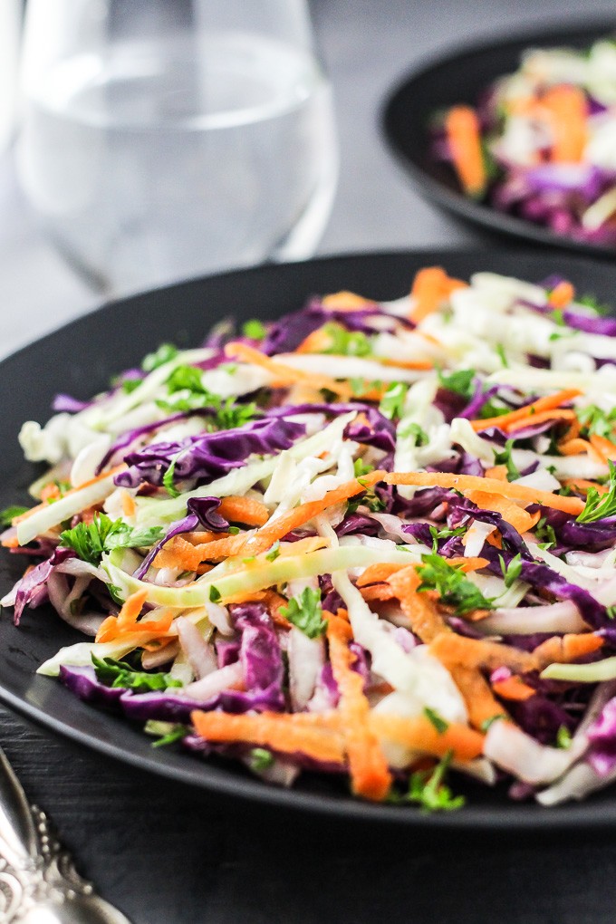 Red and green cabbage salad on a plate.