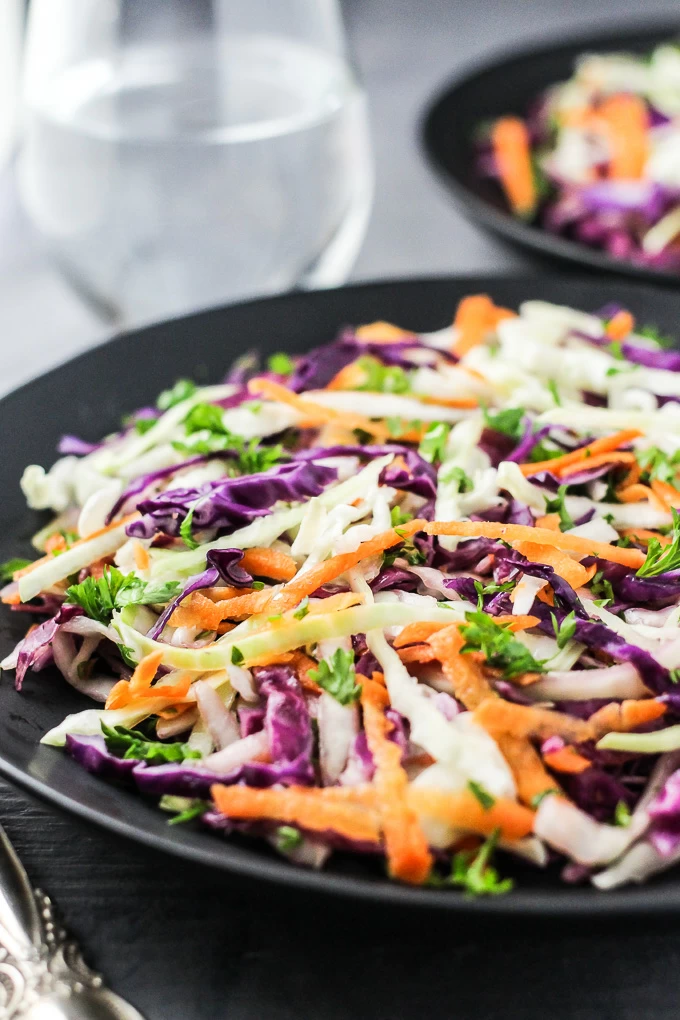 Red and green cabbage salad on a plate.