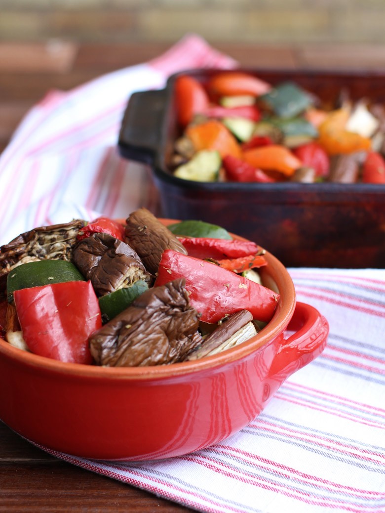 Roasted vegetables in a red bowl.