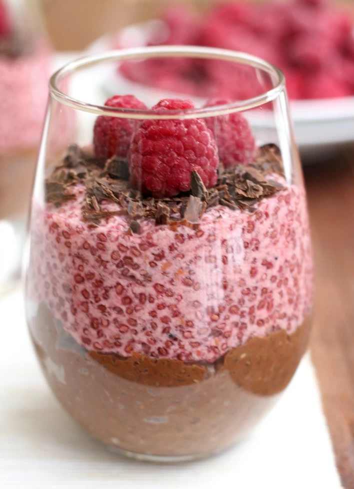Chocolate and raspberry chia pudding in a glass.