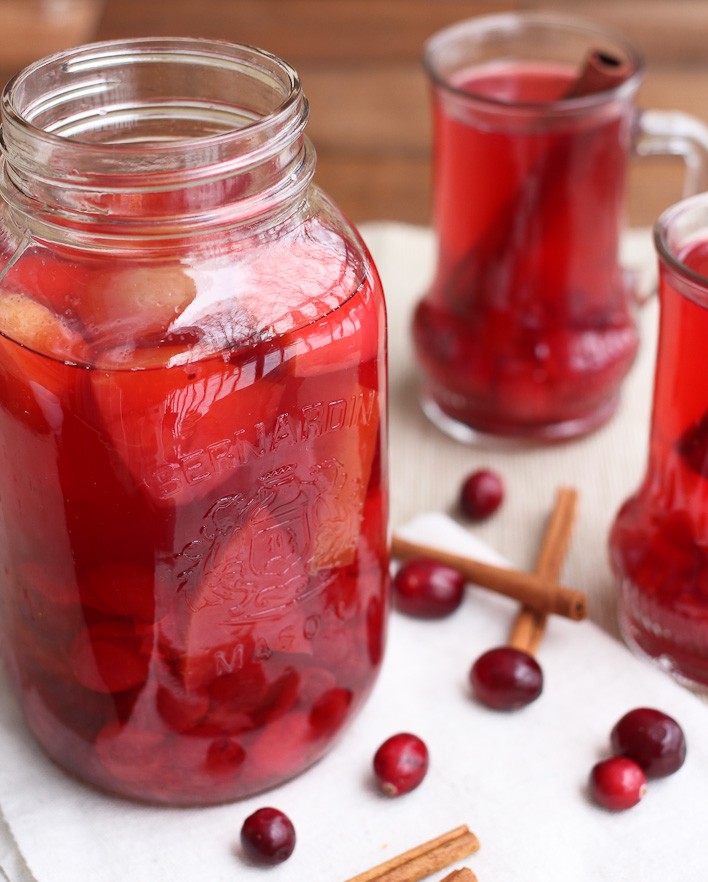 Spiced cranberry apple punch in a glass jar.