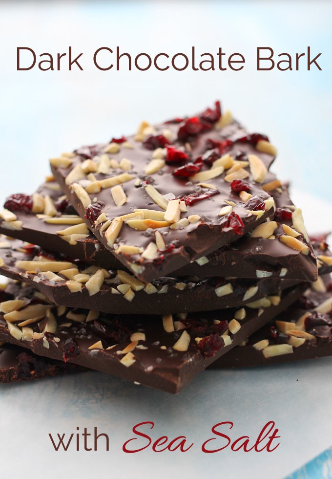 Chunks of dark chocolate bark with sea salt stack on top of each other.
