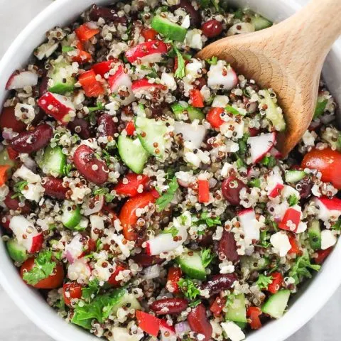 Overhead shot of the Mediterranean quinoa salad with red beans and feta in a salad bowl.