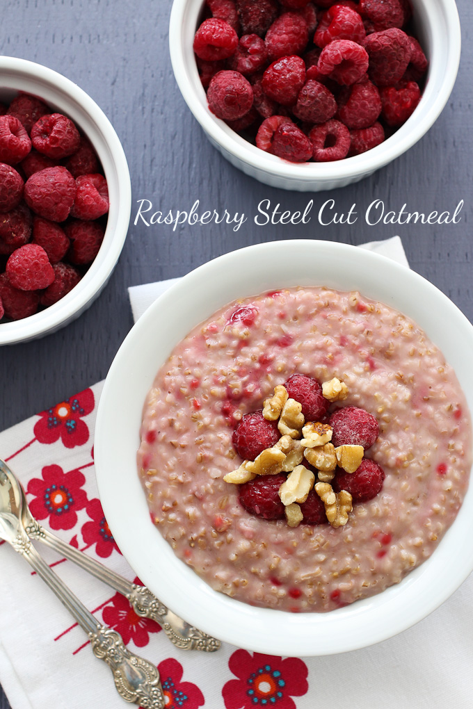 Top view of the raspberry steel cut oatmeal in a bowl, garnished with walnuts and raspberries.