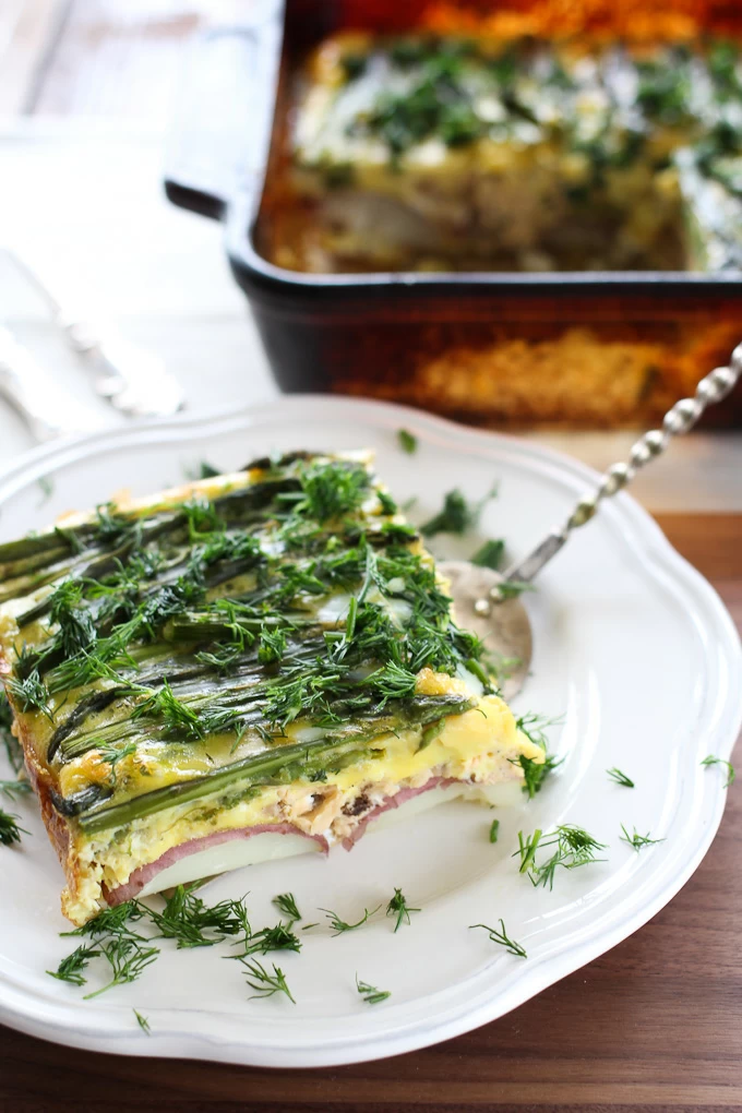 Asparagus and salmon egg bake on a white plate.
