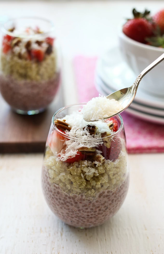 Strawberry chia and quinoa in a glass. Garnished with shredded coconut.