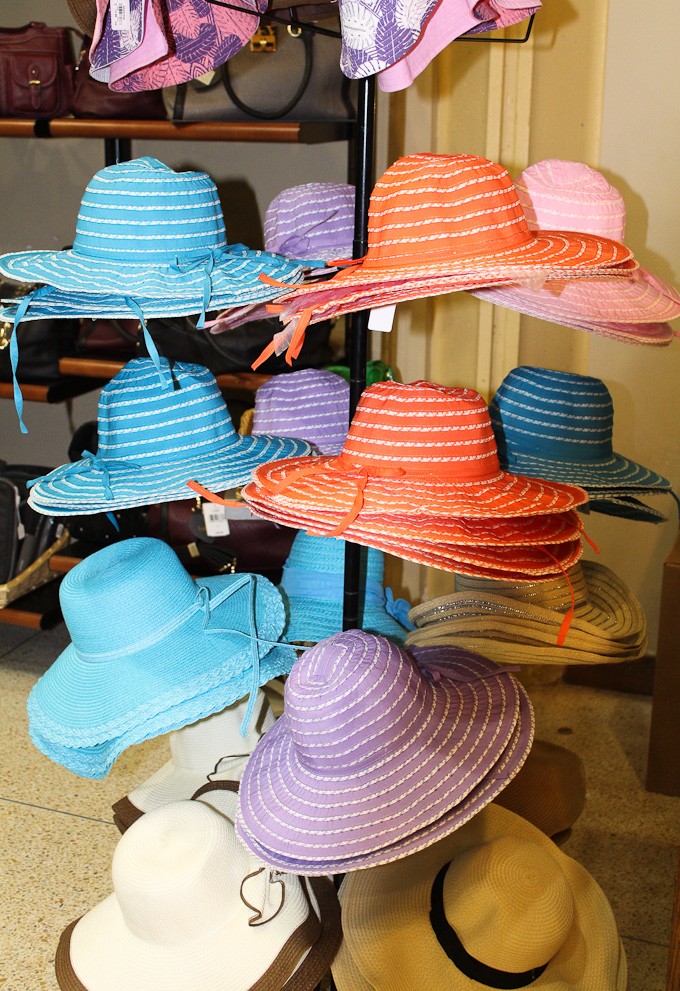 Straw hats on display at a gift shop.
