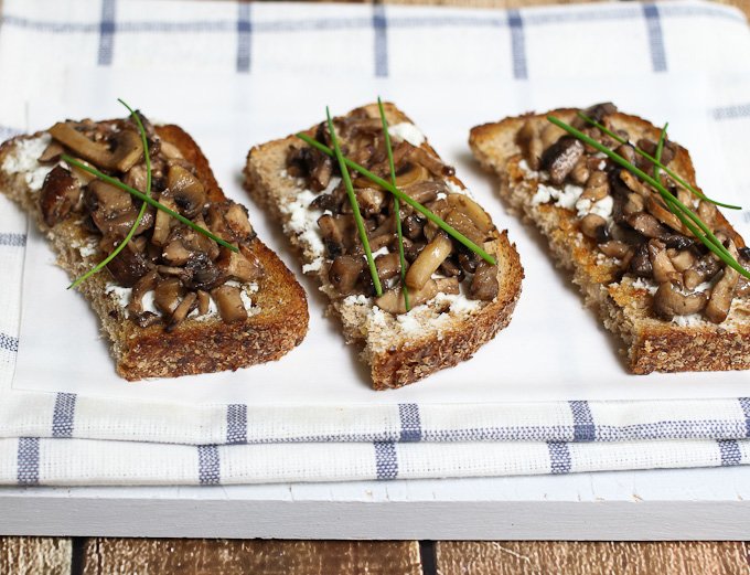 Rye bread topped with mushrooms, goat cheese, and chives.