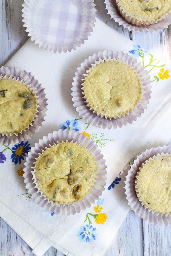 Overhead shot of the healthy cheesecake bites in cupcake liners. The cheesecake bites are sitting on a tea towel.