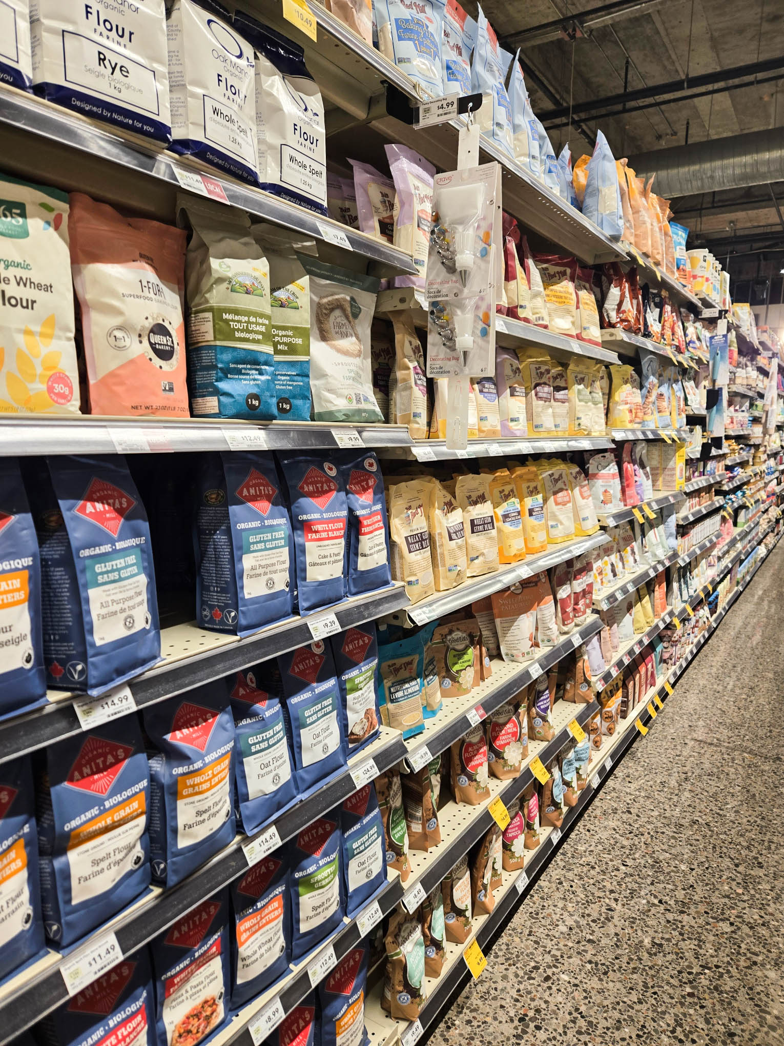 Various grains and flours in on grocery shelves.