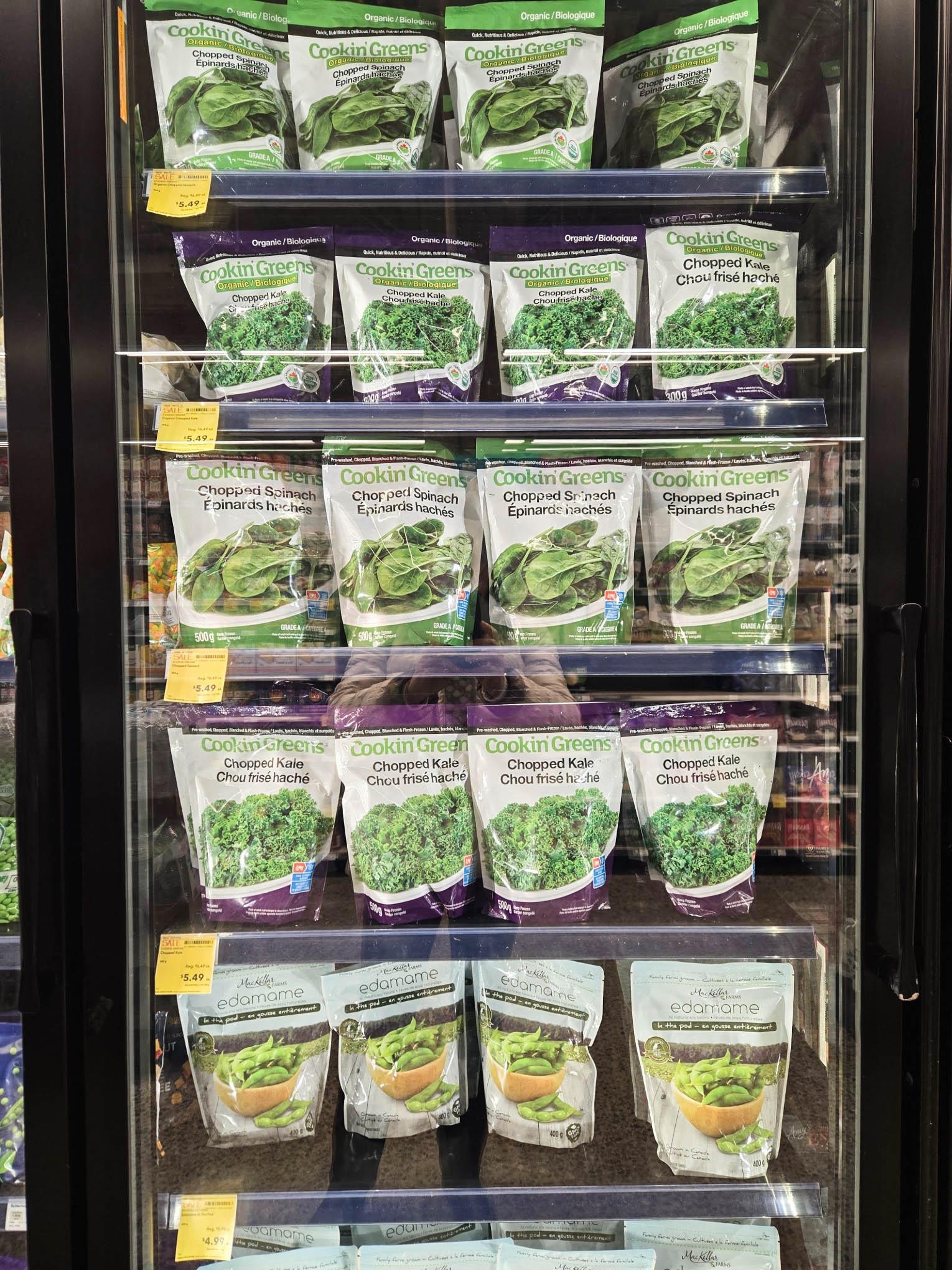 Frozen greens in a store fridge.