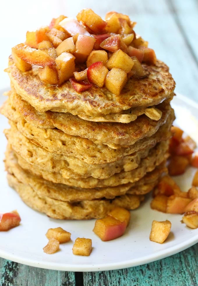 Healthy oatmeal pancakes topped with apple topping.