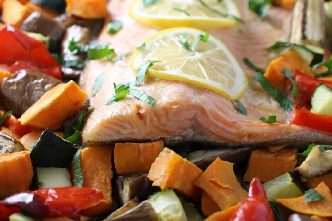 Roasted rainbow trout with chopped vegetables.