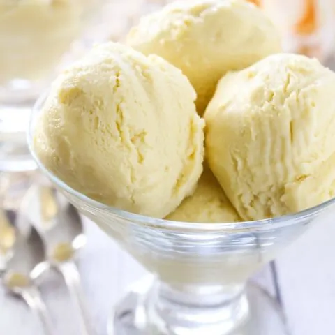 Vegan mango ice cream in a glass dessert bowl.