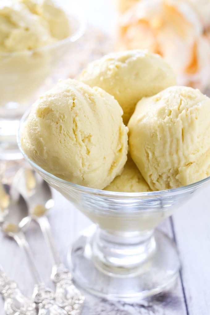 Vegan mango ice cream in a glass dessert bowl.