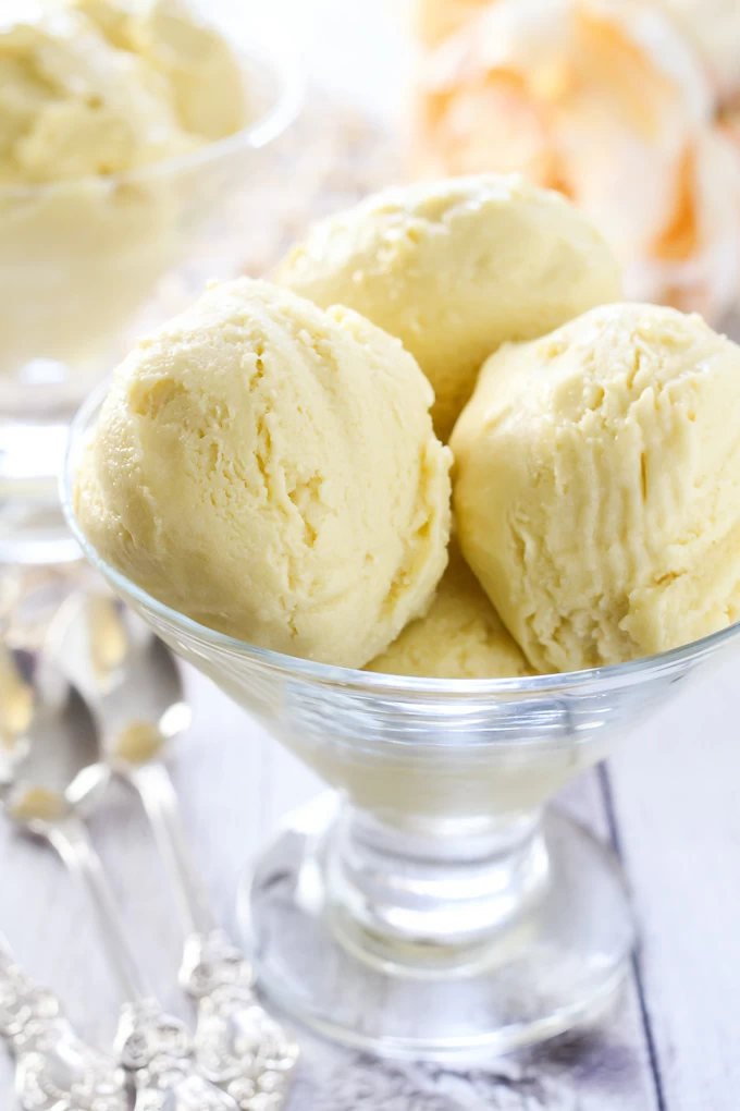 Vegan mango ice cream in a glass dessert bowl.