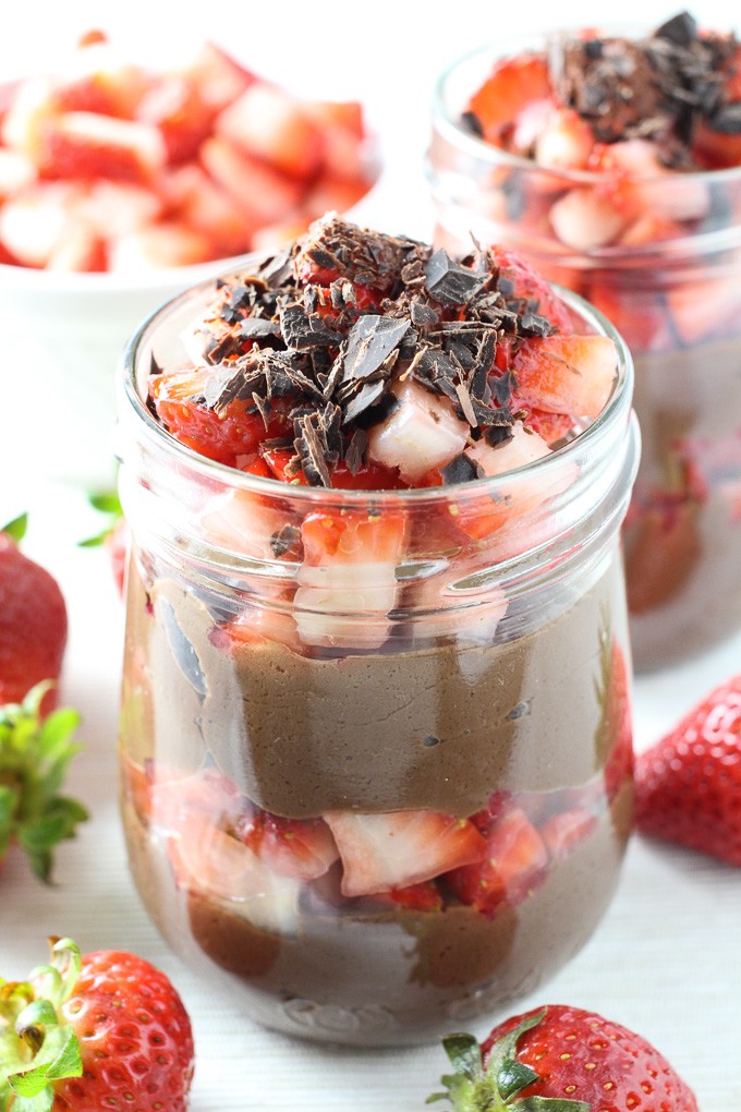 Chocolate Mousse Without Eggs in a jar, garnished with strawberries and chocolate shavings.
