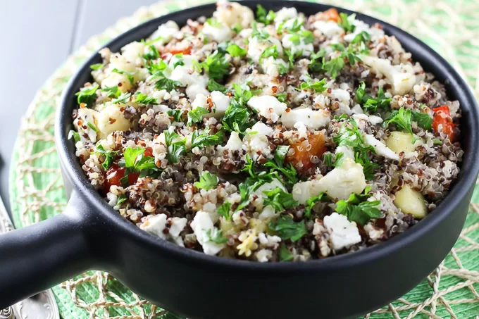 Vegetarian quinoa bake in a black pan. Side view.