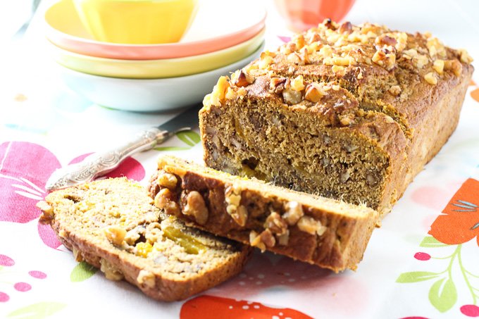 Clean eating mango bread loaf with a few slices cut off.