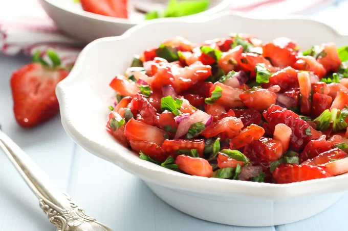 Strawberry salsa on a white plate. Side view.
