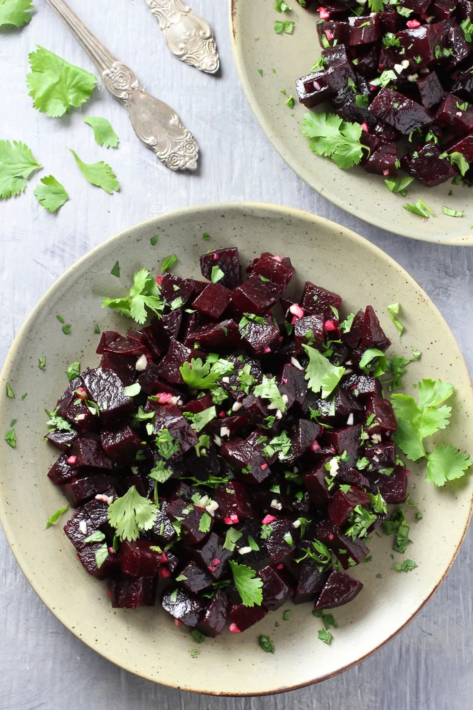Top view of the Mediterranean Beets with Garlic and Olive Oil on a plate standing on grew background.