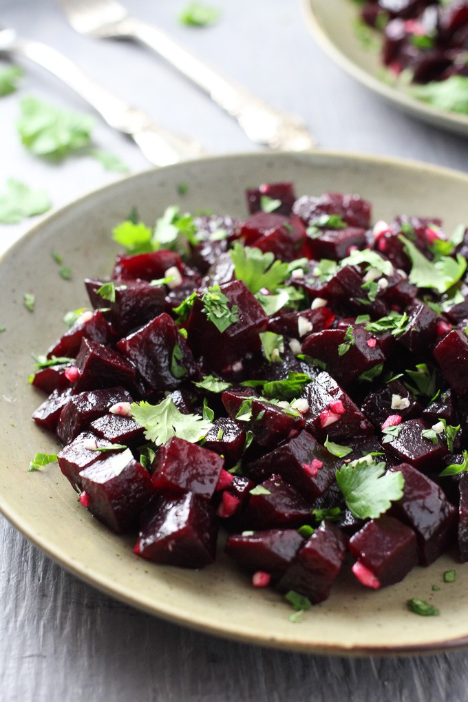 A close-up side view of Mediterranean Beets with Garlic and Olive Oil on a plate.