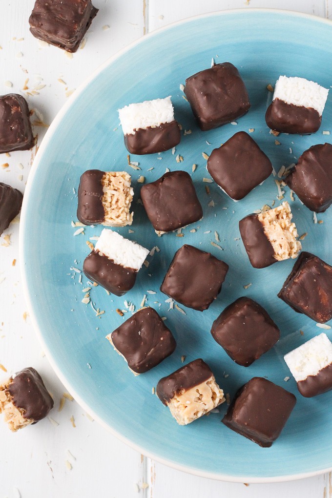 Chocolate Covered 2 Ingredient Coconut Bites on a blue plate. Top view.