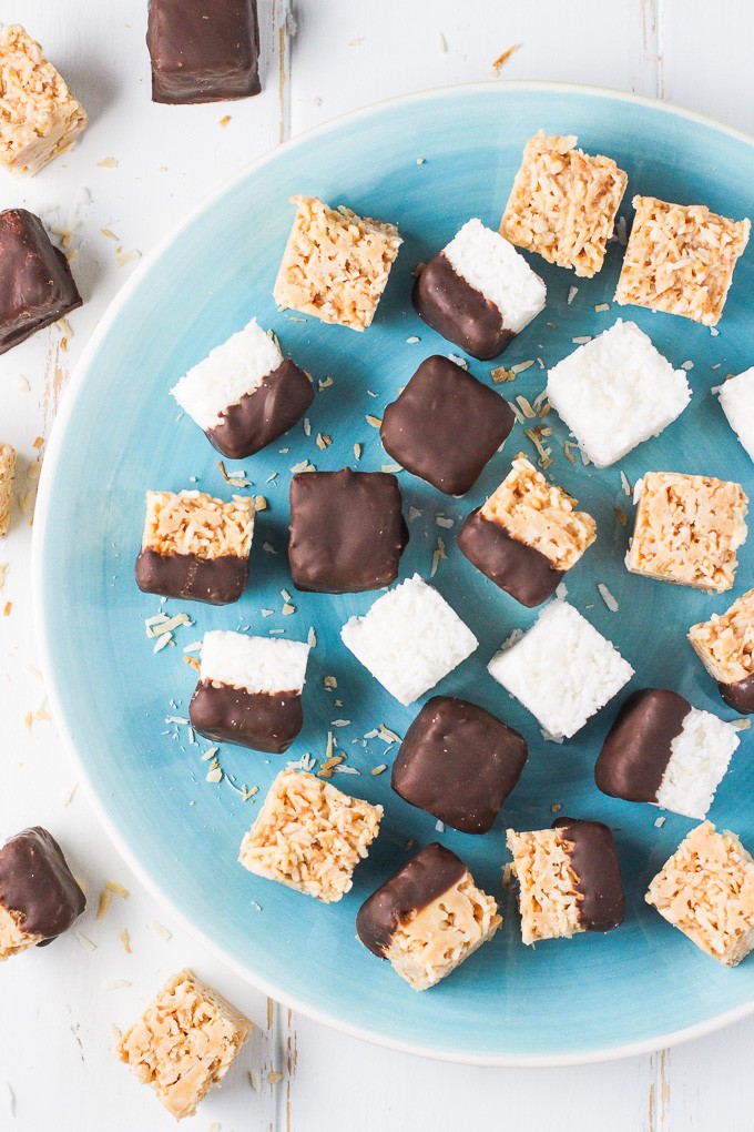 Mix of healthy coconut bites on a blue plate. Top view.