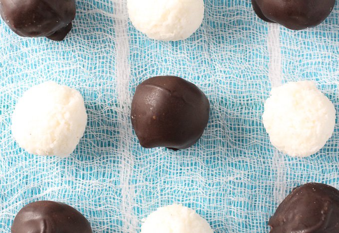 Round coconut bites on a blue background.