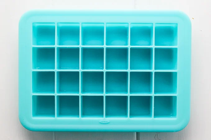 Blue silicon ice cube tray with 24 small cubes.
