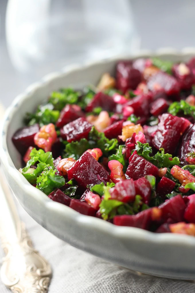 Close-up side view of the detox kale and beet salad in a grey bowl.