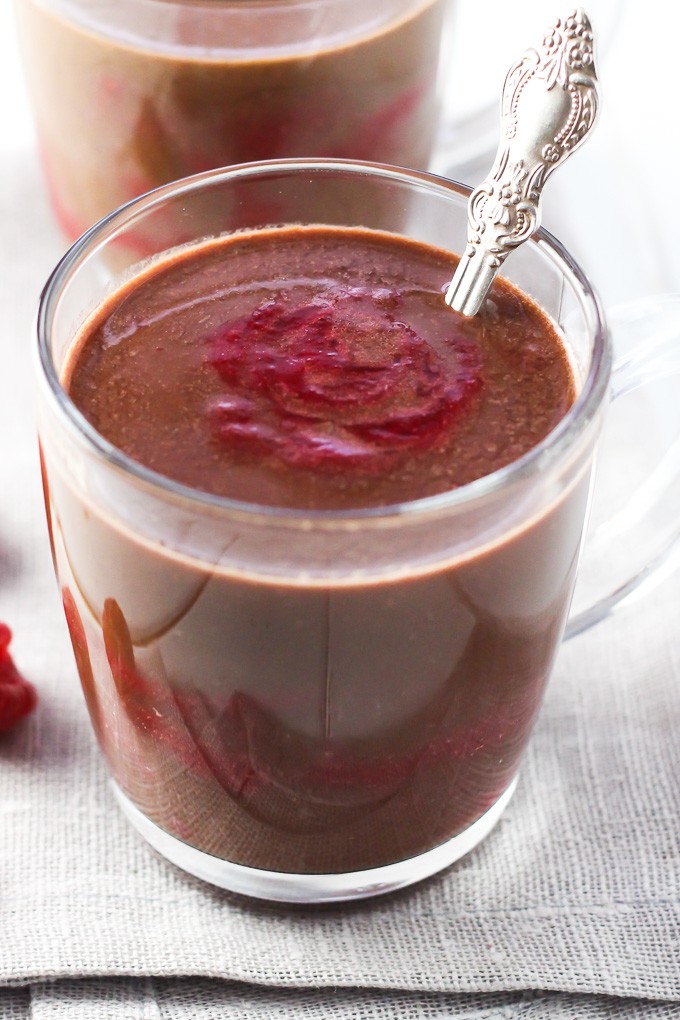 A close-up of the raspberry hot chocolate in a glass mug.
