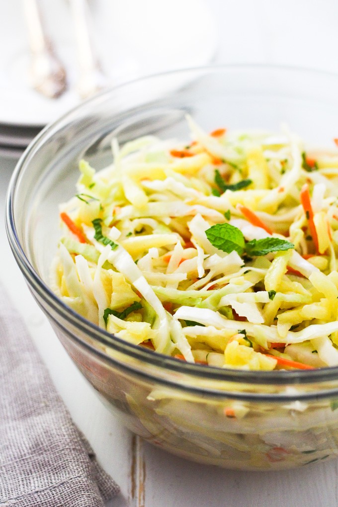 Pineapple coleslaw in a glass bowl.