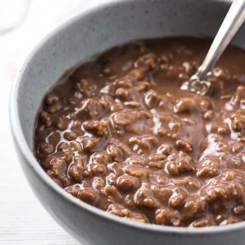 Close-up side view of the hot chocolate oatmeal in a grey bowl.