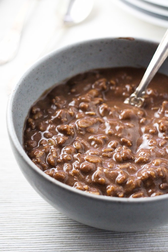 Close-up side view of the hot chocolate oatmeal in a grey bowl.