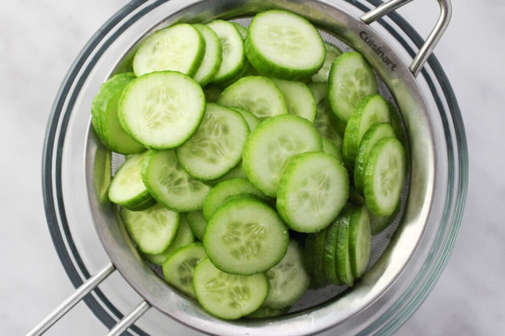 Cucumbers being drained in a collander for the salad.