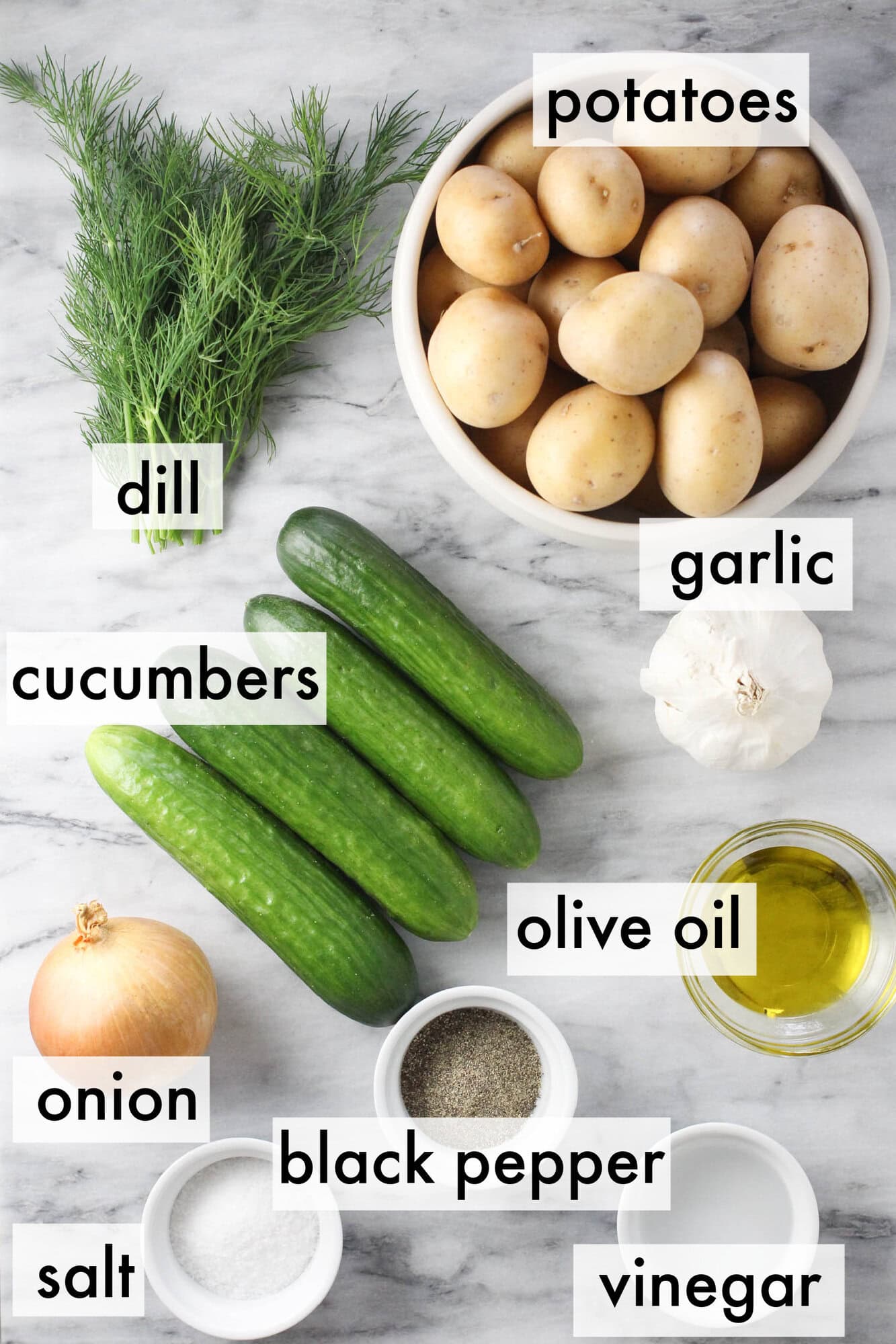 Flat lay of fresh ingredients used to make cucumber potato salad.
