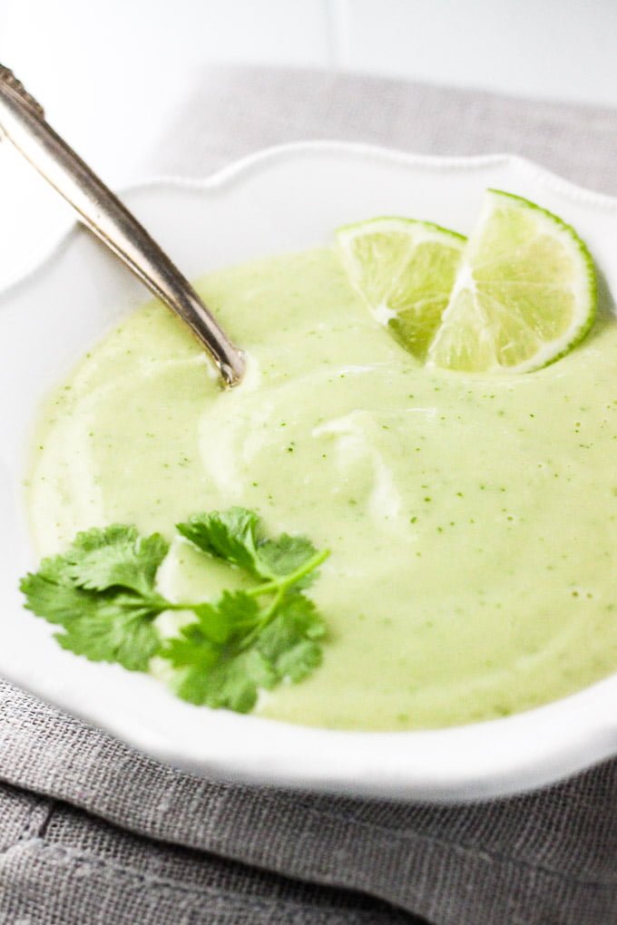 Cold avocado soup in a white bowl.