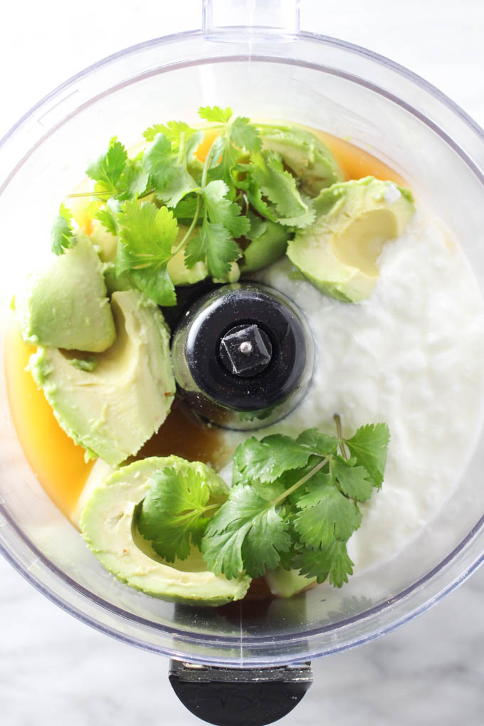 Avocado soup ingredients in a blender. Top view. 