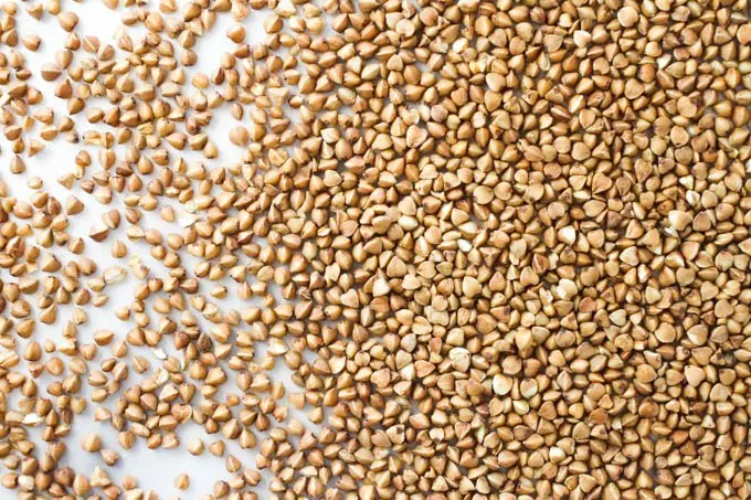 Buckwheat grains on a light background.